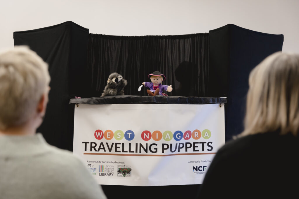 People watching traveling puppet show.