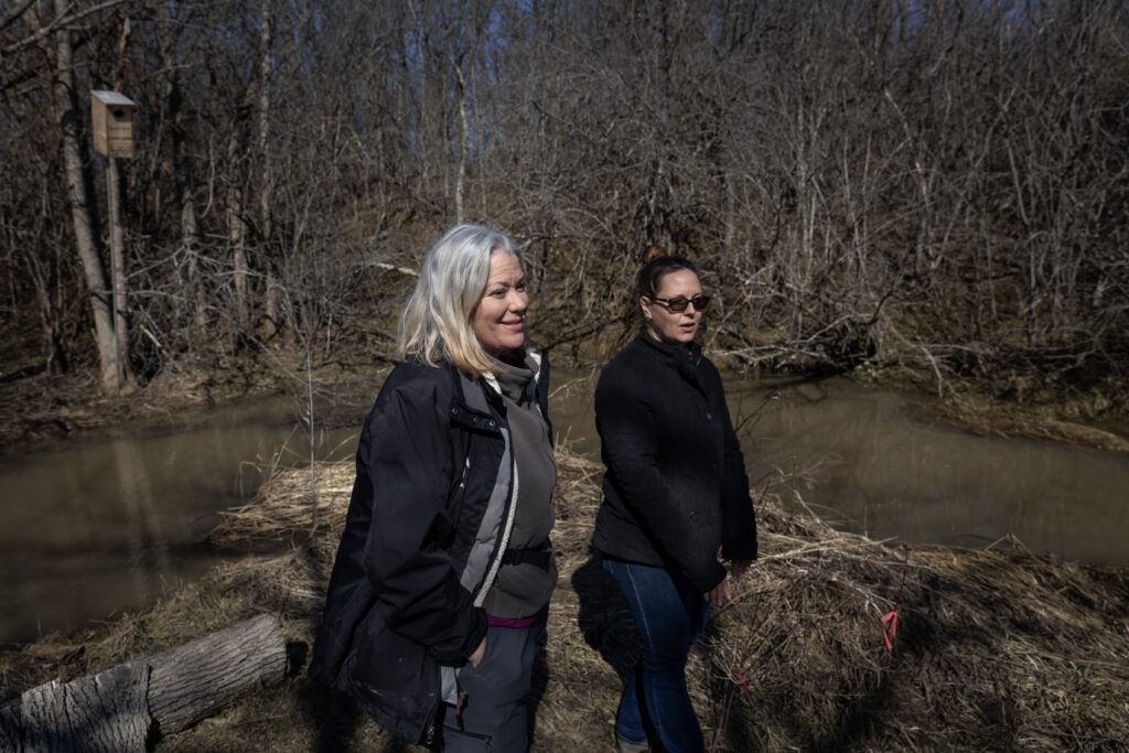 Karen van der Zalm walking next to a river with another woman