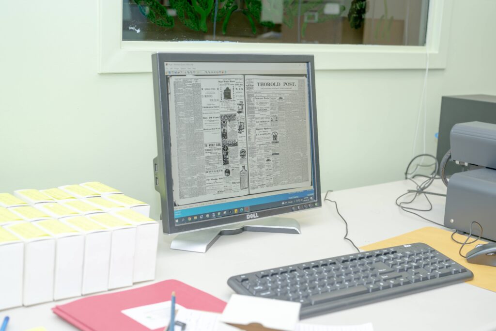 Computer displaying digitized version of 'Thorold Post'