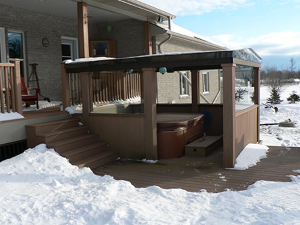Wintertime view of a spa under a gazebo