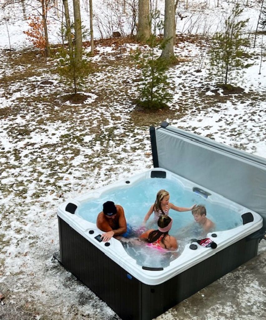 Family enjoying their spa during winter